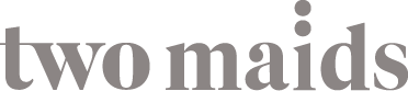 Grey text logo stating Two Maids.